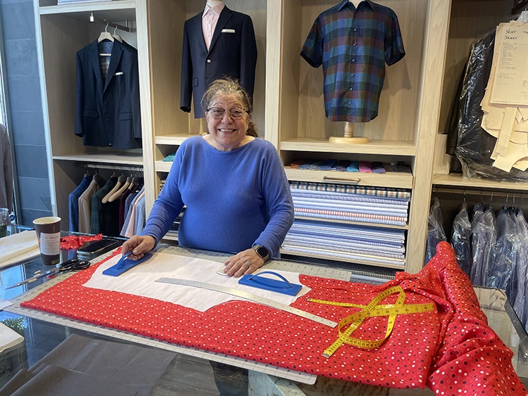 Claire cutting fabric for a bespoke shirt in the Mr. Alex atelier